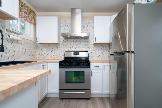 709 S Oak St, Bloomington, IL 61701 - kitchen with wooden counters, appliances with stainless steel finishes, extractor fan, a sink, and decorative backsplash