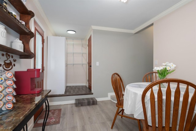 709 S Oak St, Bloomington, IL 61701 - dining area with wood finished floors, crown molding, and baseboards