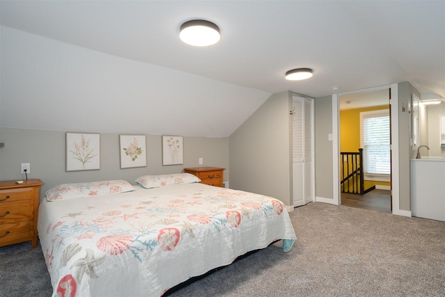 709 S Oak St, Bloomington, IL 61701 - carpeted bedroom with lofted ceiling and baseboards