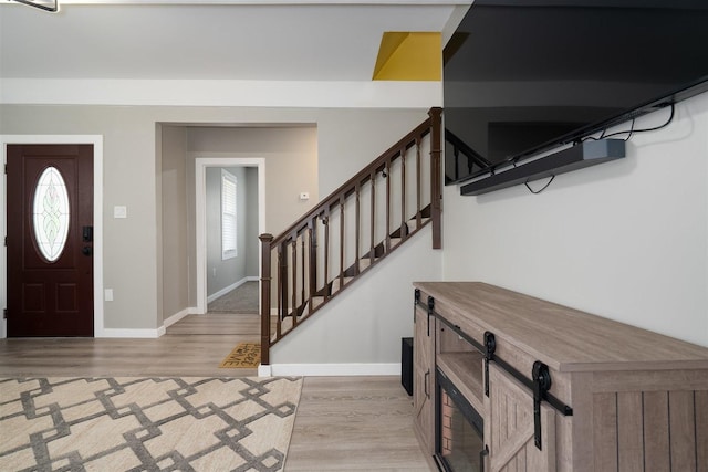 709 S Oak St, Bloomington, IL 61701 - entryway featuring light wood finished floors, healthy amount of natural light, baseboards, and stairway