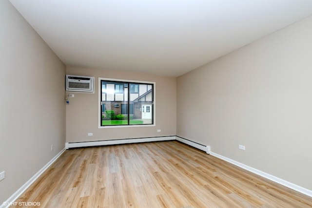 4572 W 131st St Unit 1N, Alsip, IL 60803 - spare room featuring a wall mounted AC, light wood-style flooring, baseboards, and a baseboard radiator