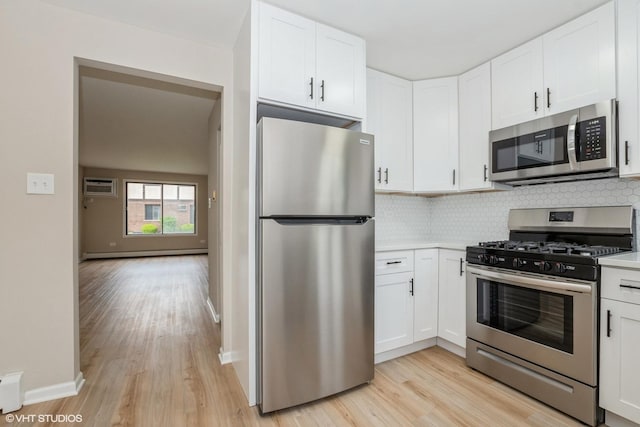 4572 W 131st St Unit 1N, Alsip, IL 60803 - kitchen featuring appliances with stainless steel finishes, baseboard heating, light wood-style floors, and decorative backsplash