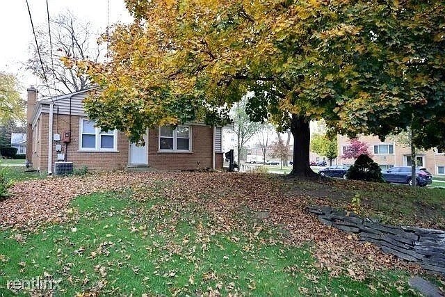 142 E Grove St, Lombard, IL 60148 - view of side of property featuring brick siding, central AC unit, and a chimney