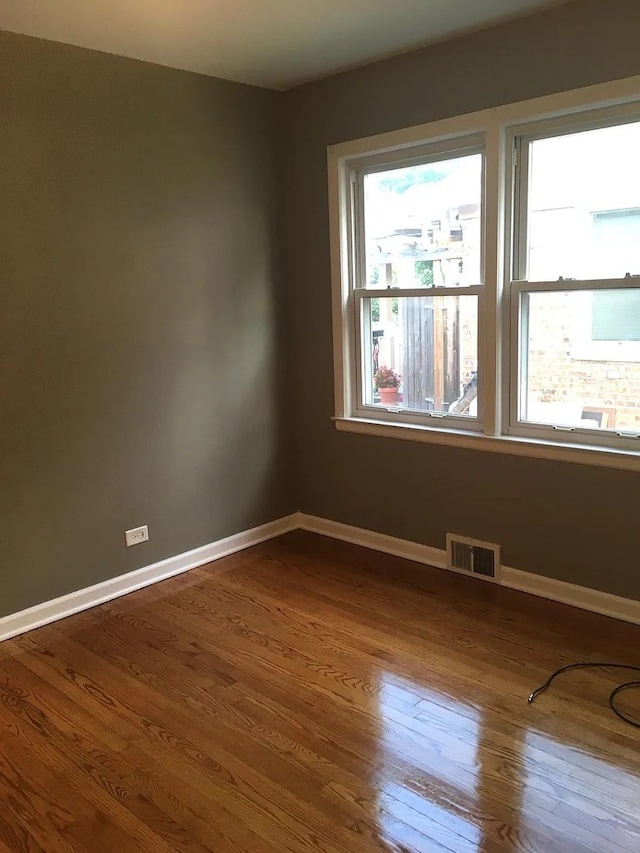 142 E Grove St, Lombard, IL 60148 - unfurnished room with dark wood-style floors and baseboards
