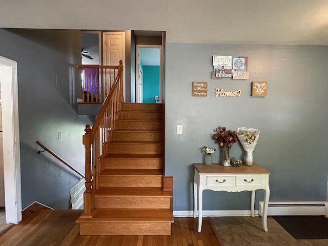 165 Kathleen Dr, Elgin, IL 60123 - stairway featuring wood finished floors, baseboard heating, and baseboards