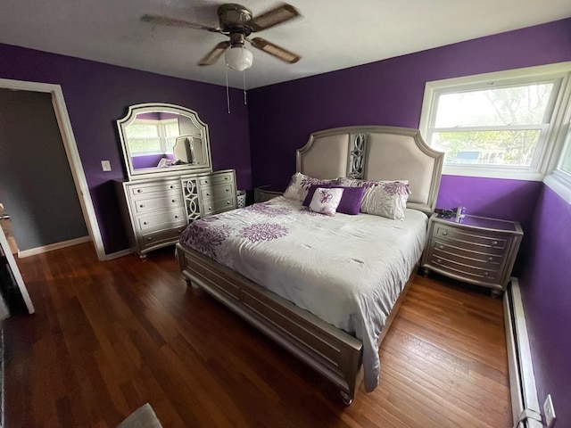 165 Kathleen Dr, Elgin, IL 60123 - bedroom with a baseboard heating unit, multiple windows, and wood finished floors