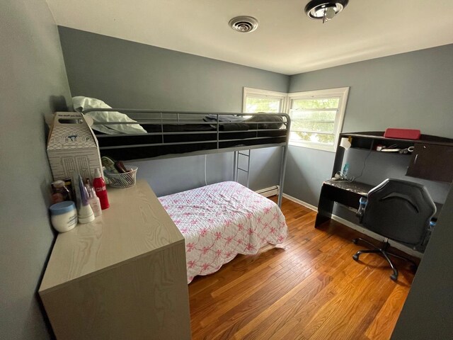 165 Kathleen Dr, Elgin, IL 60123 - bedroom with wood finished floors, a baseboard heating unit, and baseboards