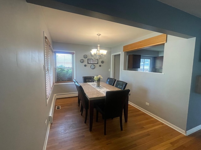 165 Kathleen Dr, Elgin, IL 60123 - dining room featuring a chandelier, baseboards, a baseboard radiator, and wood finished floors