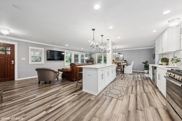 805 S Main St, Wheaton, IL 60189 - kitchen with a chandelier, light countertops, baseboards, appliances with stainless steel finishes, and ornamental molding