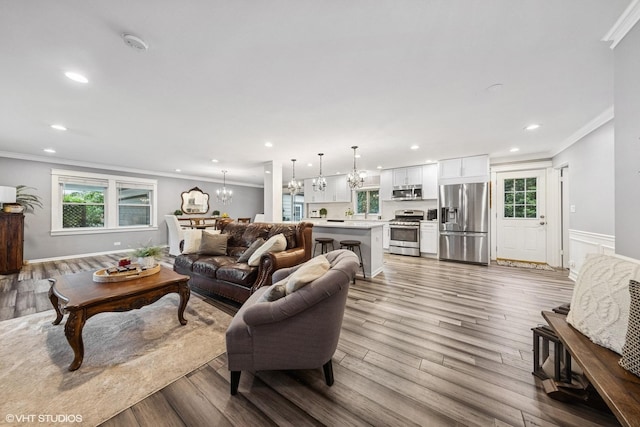 805 S Main St, Wheaton, IL 60189 - living area featuring crown molding, a chandelier, recessed lighting, plenty of natural light, and wood finished floors