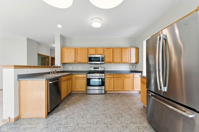 16517 Newbury Ct, Crest Hill, IL 60403 - kitchen with stainless steel appliances, dark countertops, a peninsula, and light tile patterned floors