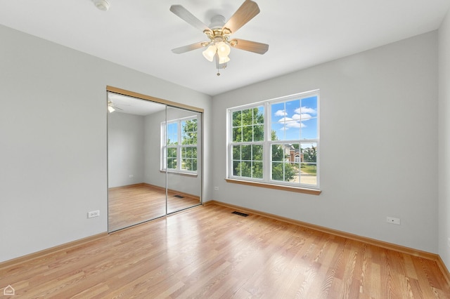16517 Newbury Ct, Crest Hill, IL 60403 - unfurnished bedroom featuring wood finished floors, a closet, and a ceiling fan