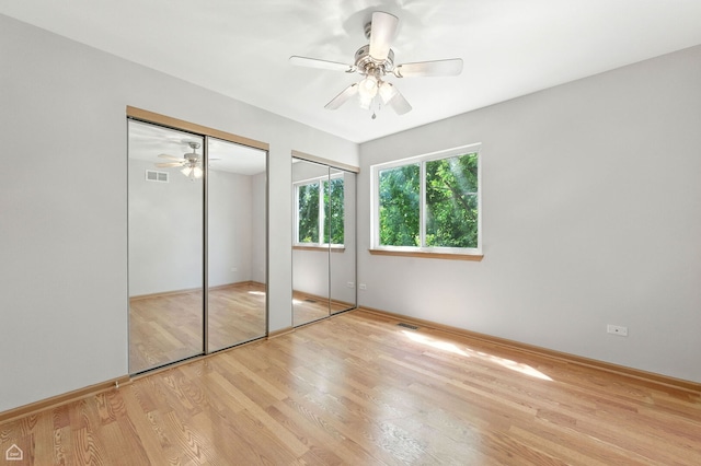 16517 Newbury Ct, Crest Hill, IL 60403 - unfurnished bedroom with multiple closets, light wood-style flooring, and ceiling fan