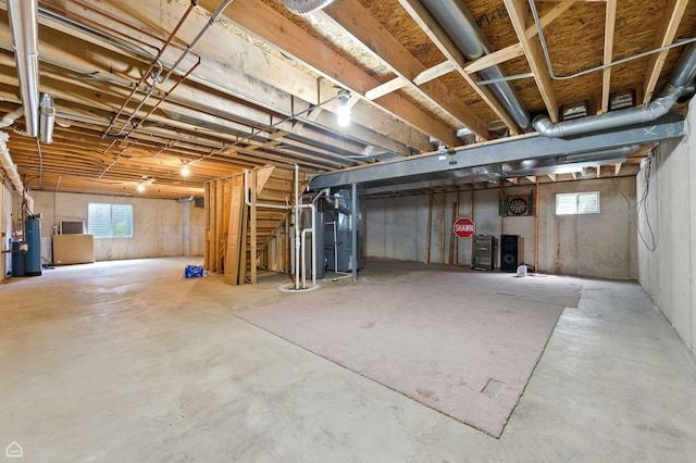 16517 Newbury Ct, Crest Hill, IL 60403 - below grade area featuring healthy amount of natural light, gas water heater, drainage system, and heating unit