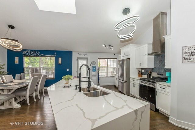 6016 W Kennedy Ct, Monee, IL 60449 - kitchen with stainless steel appliances, a sink, a center island with sink, white cabinets, and wall chimney exhaust hood