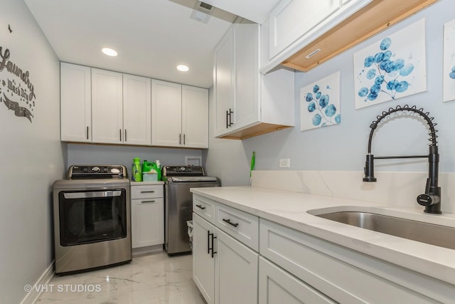 6016 W Kennedy Ct, Monee, IL 60449 - kitchen with light marble finish flooring, a sink, washing machine and dryer, recessed lighting, and white cabinetry