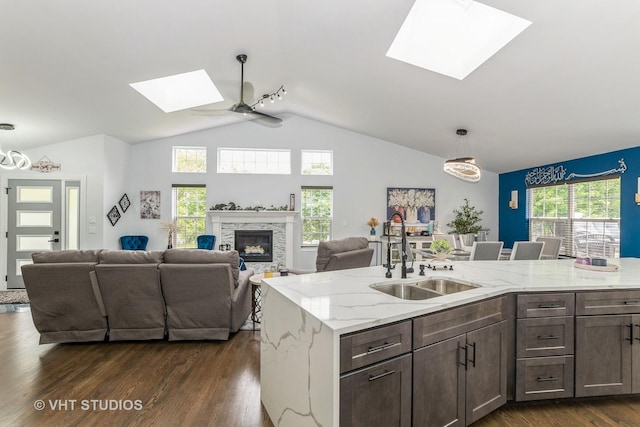 6016 W Kennedy Ct, Monee, IL 60449 - kitchen with a skylight, a sink, lofted ceiling, a ceiling fan, and dark wood-style flooring