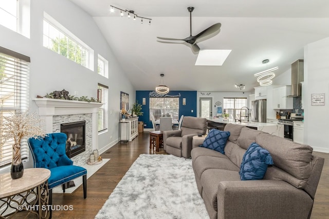 6016 W Kennedy Ct, Monee, IL 60449 - living room featuring plenty of natural light, a skylight, a ceiling fan, dark wood-style flooring, and high vaulted ceiling