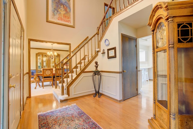 13711 83rd Ave, Orland Park, IL 60462 - foyer with wood finished floors, stairway, a chandelier, wainscoting, and a decorative wall