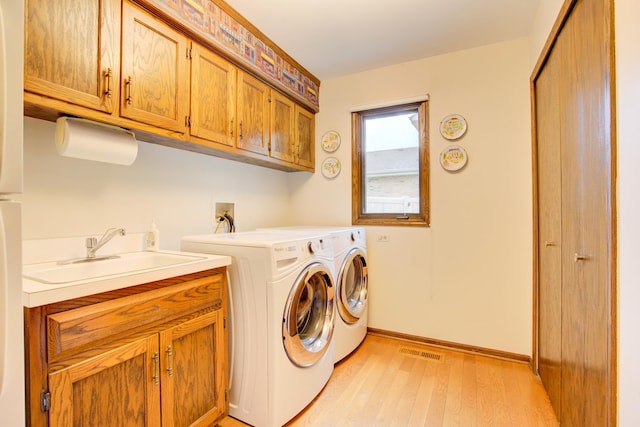 13711 83rd Ave, Orland Park, IL 60462 - laundry room featuring cabinet space, washing machine and dryer, light wood finished floors, and baseboards