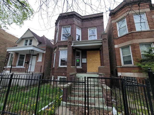 5732 S Sangamon St, Chicago, IL 60621 - view of front of property with brick siding, a fenced front yard, and a porch