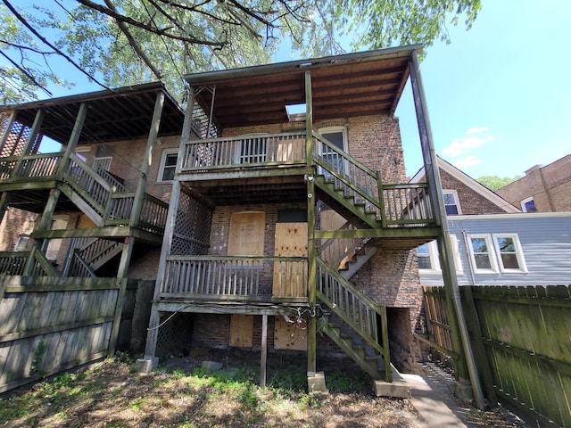 5732 S Sangamon St, Chicago, IL 60621 - back of house featuring stairs, a fenced backyard, brick siding, and a deck