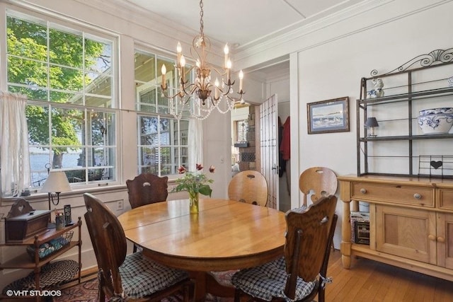 4014 Pitzen Rd, Johnsburg, IL 60051 - dining space featuring a chandelier, ornamental molding, plenty of natural light, and light wood finished floors