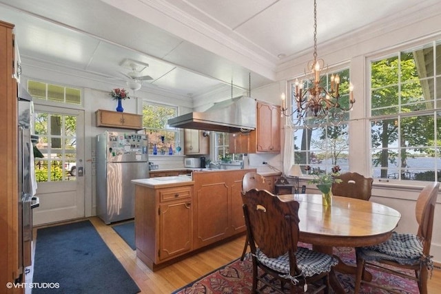 4014 Pitzen Rd, Johnsburg, IL 60051 - dining space with light wood finished floors, a chandelier, and crown molding