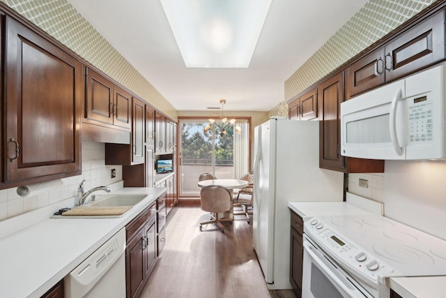 6400 N Cicero Ave Unit 404, Lincolnwood, IL 60712 - kitchen featuring white appliances, a sink, light countertops, light wood finished floors, and backsplash