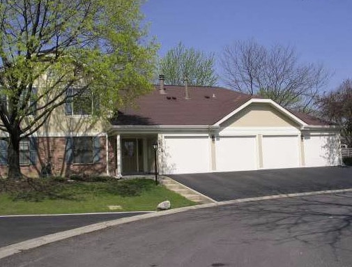 1182 Middlebury Ln Unit D1, Wheeling, IL 60090 - view of front of property with driveway and an attached garage