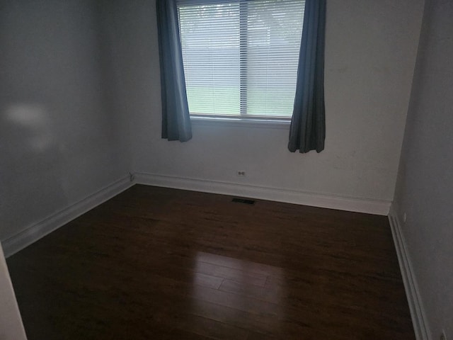 1182 Middlebury Ln Unit D1, Wheeling, IL 60090 - unfurnished room featuring dark wood-style flooring and baseboards