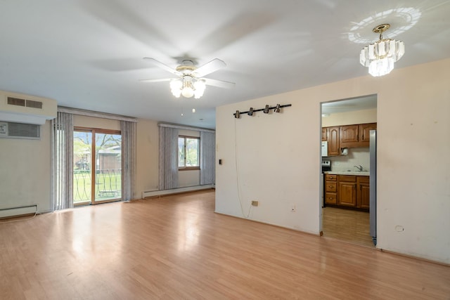 1210 N Dale Ave Unit 2I, Arlington Heights, IL 60004 - unfurnished living room featuring light wood-style flooring, baseboard heating, a ceiling fan, a chandelier, and a baseboard heating unit
