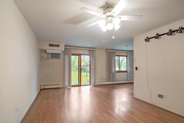 1210 N Dale Ave Unit 2I, Arlington Heights, IL 60004 - empty room with a baseboard radiator, baseboard heating, ceiling fan, light wood-style floors, and a wall mounted air conditioner