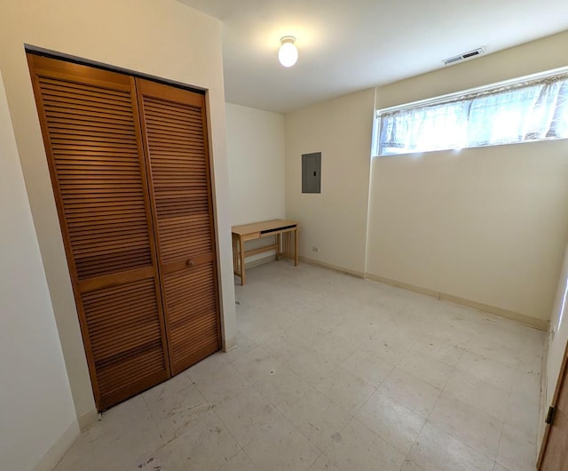 3383 S Archer Ave, Chicago, IL 60608 - unfurnished bedroom with a closet, electric panel, light flooring, and baseboards