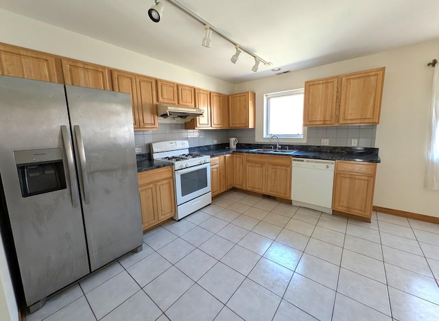 3383 S Archer Ave, Chicago, IL 60608 - kitchen featuring white appliances, under cabinet range hood, light tile patterned floors, dark countertops, and a sink