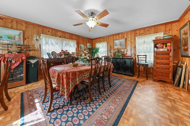605 E St, Mazon, IL 60444 - dining space with wood walls, plenty of natural light, a ceiling fan, and ornamental molding