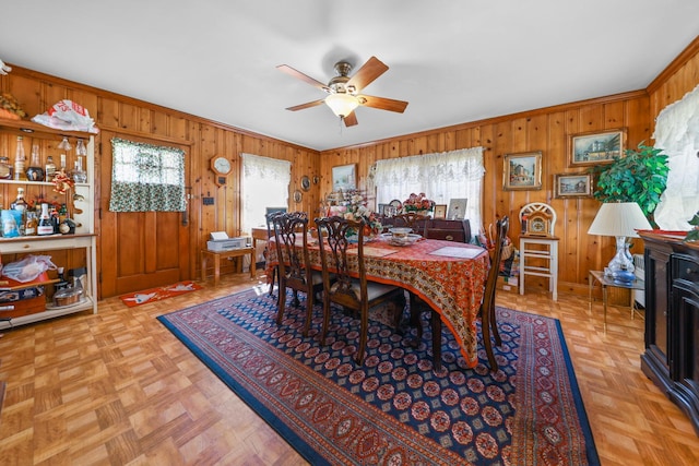 605 E St, Mazon, IL 60444 - dining room featuring wood walls, a ceiling fan, and crown molding