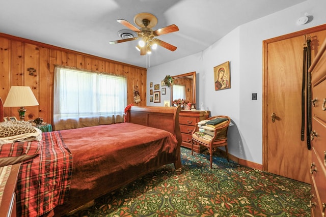 605 E St, Mazon, IL 60444 - carpeted bedroom with baseboards, a ceiling fan, and wooden walls