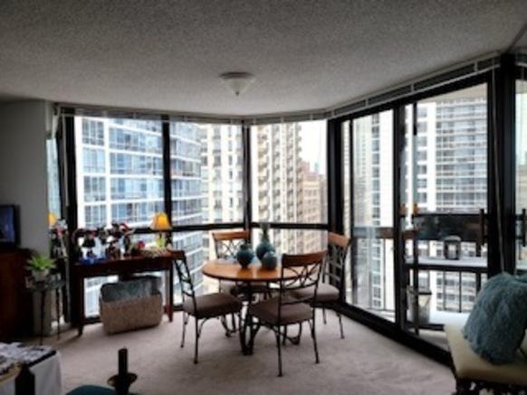 33 W Delaware Pl Unit 18B, Chicago, IL 60610 - unfurnished living room featuring carpet, a textured ceiling, and healthy amount of natural light