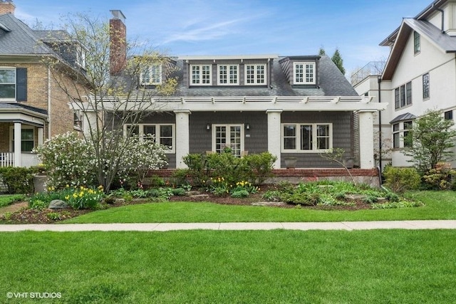 2400 Park Pl, Evanston, IL 60201 - view of front facade with a front yard, a chimney, and roof with shingles