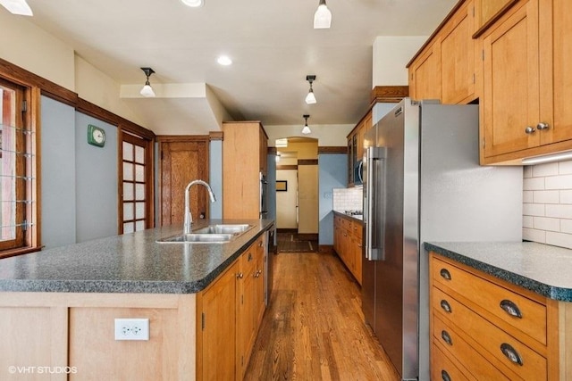 2400 Park Pl, Evanston, IL 60201 - kitchen with a sink, stainless steel appliances, dark countertops, wood finished floors, and backsplash