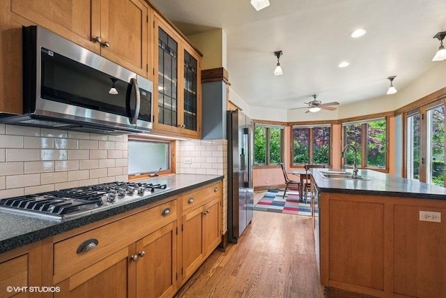 2400 Park Pl, Evanston, IL 60201 - kitchen featuring appliances with stainless steel finishes, a sink, plenty of natural light, brown cabinetry, and recessed lighting