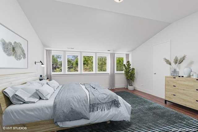 2400 Park Pl, Evanston, IL 60201 - bedroom with vaulted ceiling, wood finished floors, multiple windows, and baseboards