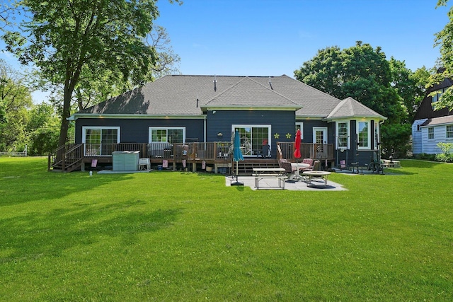 2215 N Woodlawn Park Ave, Mchenry, IL 60051 - rear view of house featuring a wooden deck, a patio, a yard, and roof with shingles
