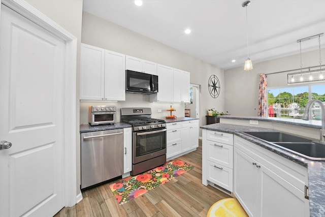 2215 N Woodlawn Park Ave, Mchenry, IL 60051 - kitchen featuring appliances with stainless steel finishes, a sink, light wood-type flooring, white cabinets, and recessed lighting