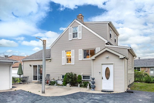 11030 S Nagle Ave, Worth, IL 60482 - view of front of house with a chimney and a patio area