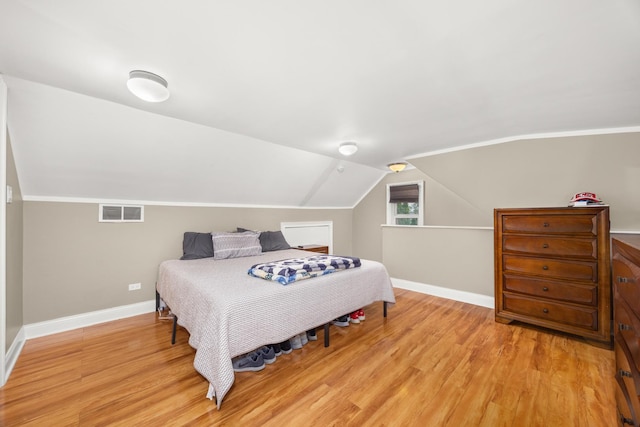 11030 S Nagle Ave, Worth, IL 60482 - bedroom featuring baseboards, light wood-style floors, and vaulted ceiling