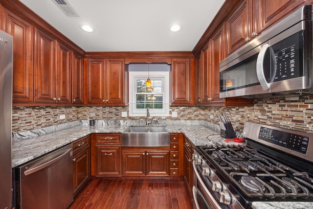 11030 S Nagle Ave, Worth, IL 60482 - kitchen with stainless steel appliances, a sink, light stone countertops, and dark wood-style floors