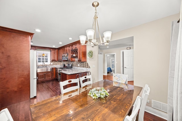 11030 S Nagle Ave, Worth, IL 60482 - dining room with dark wood-style flooring, a chandelier, baseboards, and recessed lighting
