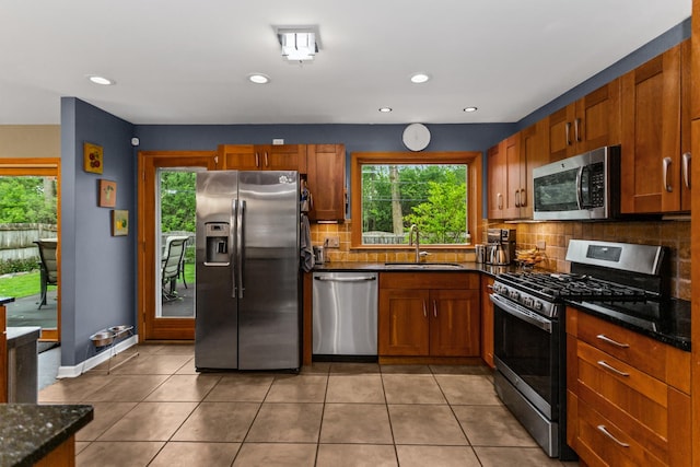 1101 Juniper Ter, Glenview, IL 60025 - kitchen with stainless steel appliances, a sink, tasteful backsplash, light tile patterned floors, and recessed lighting